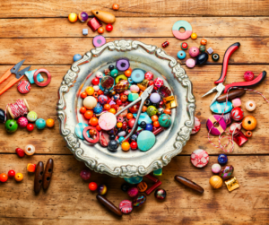 beads sprawled on a wooden table on and in a bowl